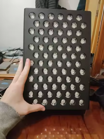 Tabletop panel held up showing the full front LED grid
