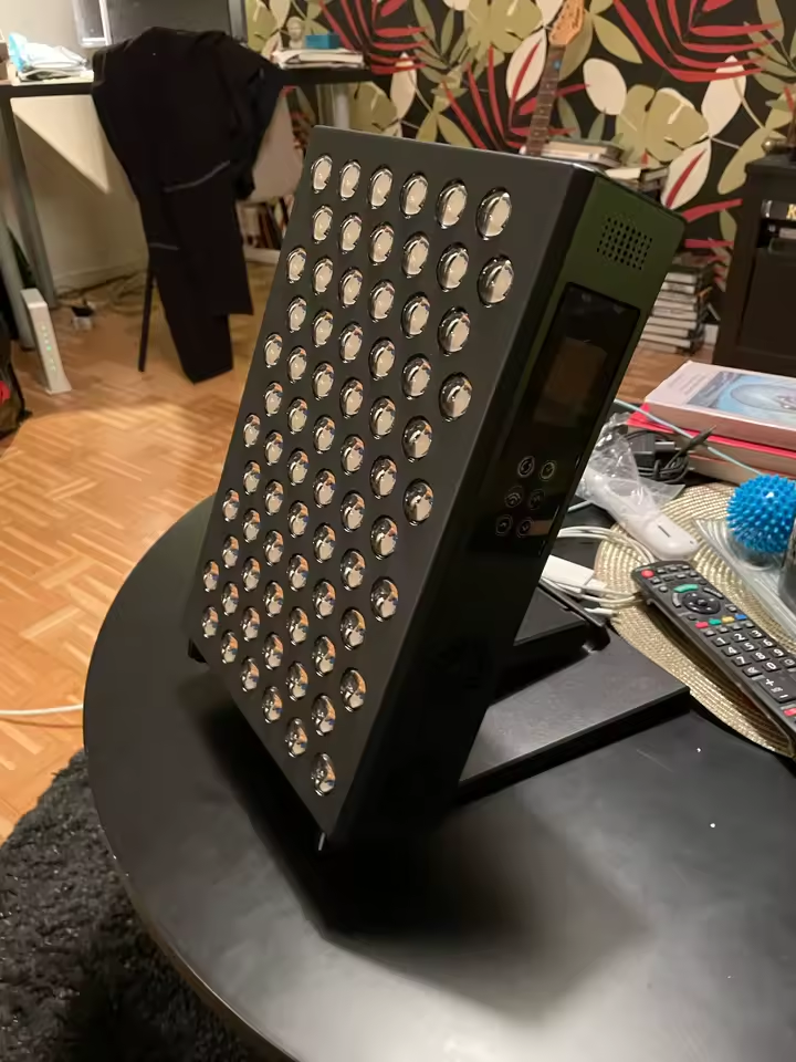 The Tabletop on a round table in a living room, on its kickstand, control panel visible