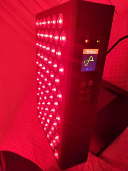 Tabletop on a bed during an evening session, red light filling the room