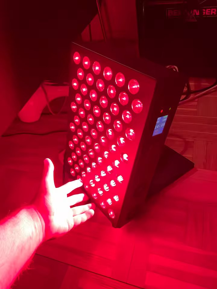 The Tabletop with a customer's hand reaching toward the panel for scale, full red light output